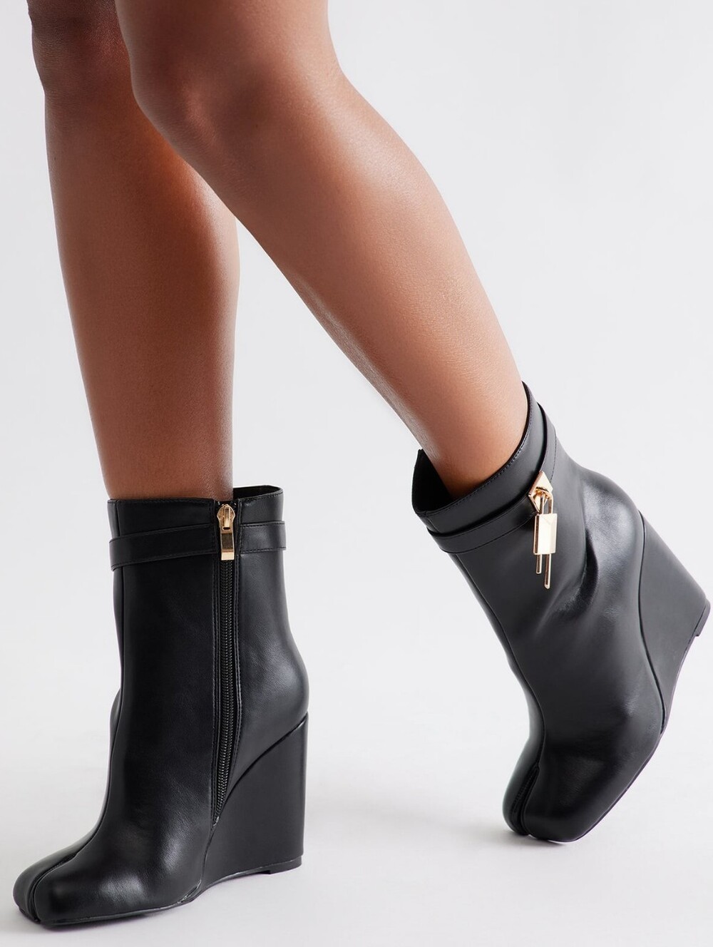 Women's black wedge ankle boots with a unique and bold design